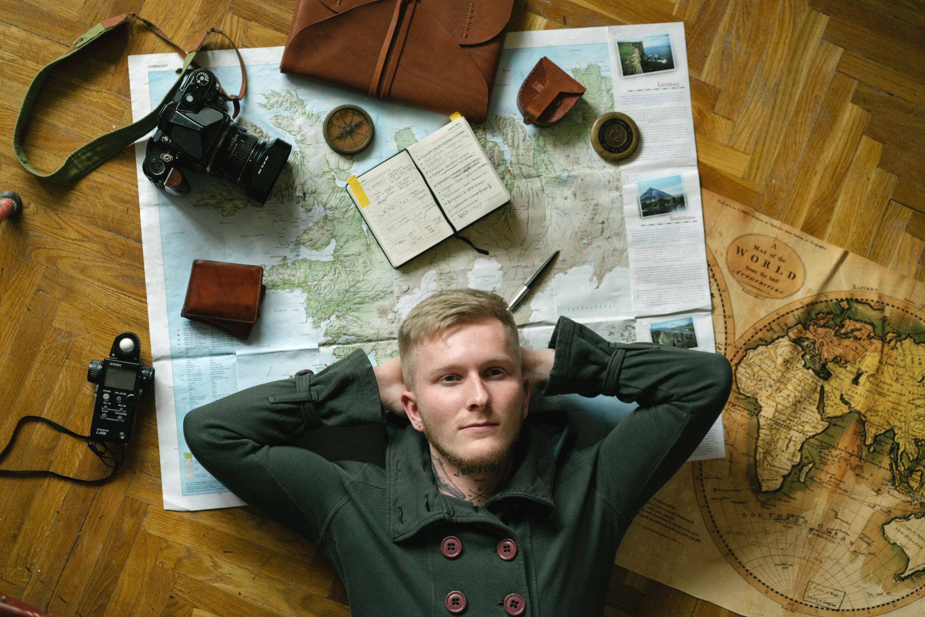 Travel writer examining maps at an alpine lodge desk